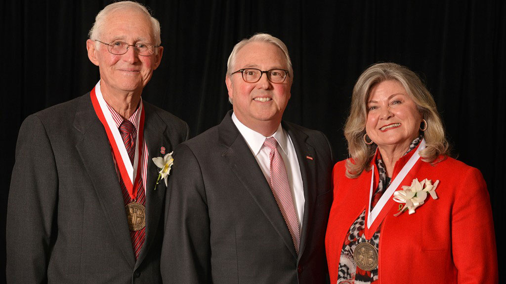 Lynn Eury and Judi Grainger pause for a photo with Chancellor Randy Woodson at the conclusion of the 2015 Founders' Day and Watauga Medal Celebration.