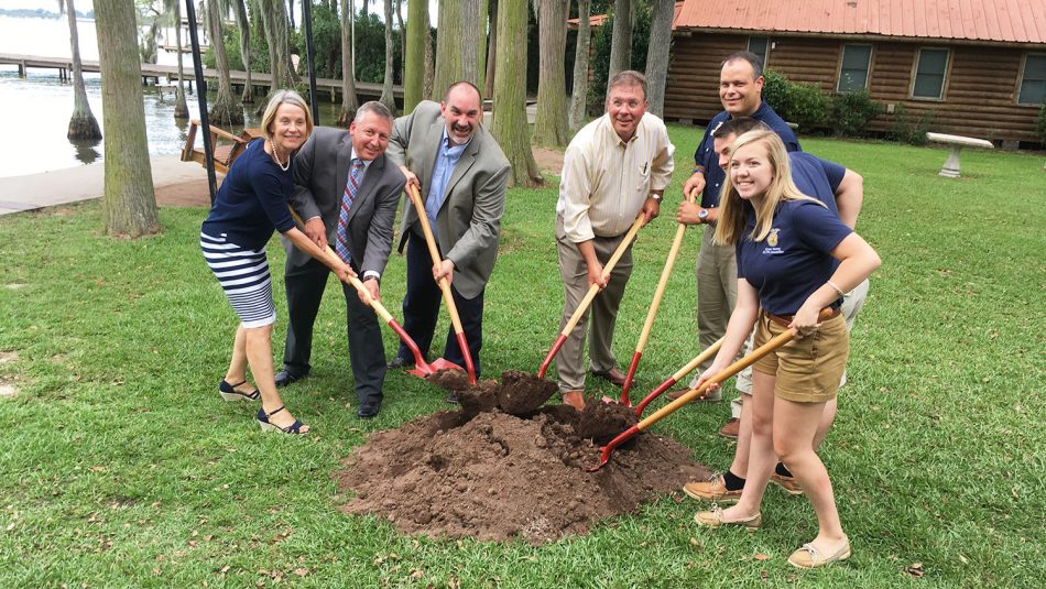 stakeholders pose with shovels at groundbreaking