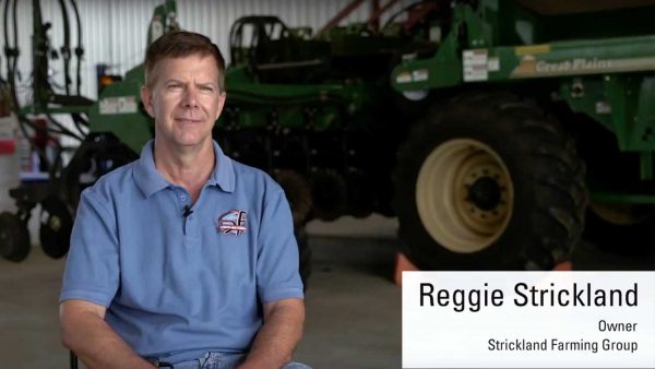 Reggie Strickland sits in front of a tractor