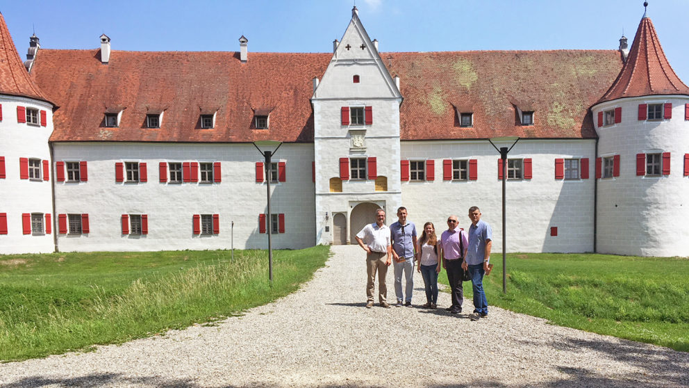 Meredith Bain poses in front of German architecture with friends