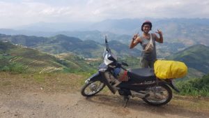 Soumya Nadabar poses with a bike in front of mountains