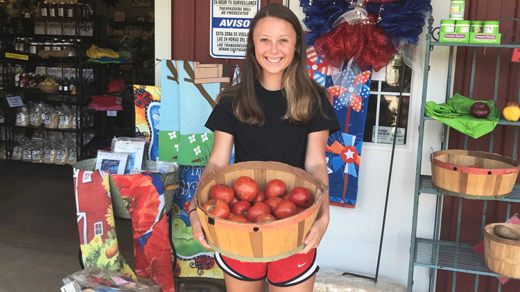 Victoria Patterson holding a basket of apples