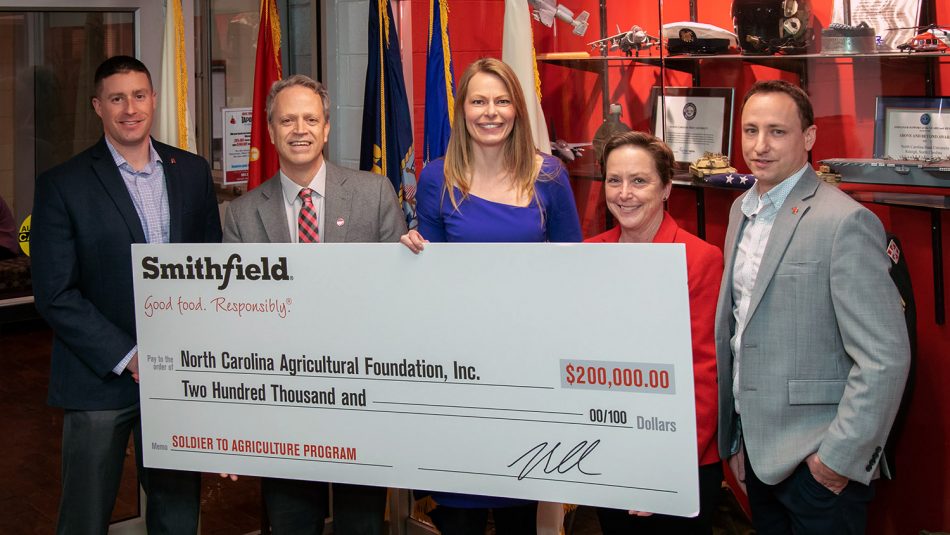 Smithfield and CALS leadership with donation check
