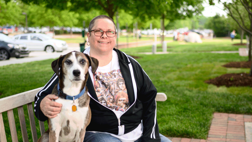 Sharon Davis and dog Zeevy on a bench