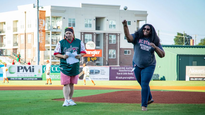 Danielle Barnes throws out the first pitch at a Greensboro Grasshoppers game