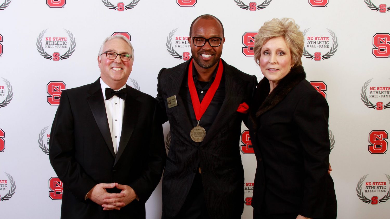 Torry Holt with Chancellor Woodson and Debbie Yow in 2013