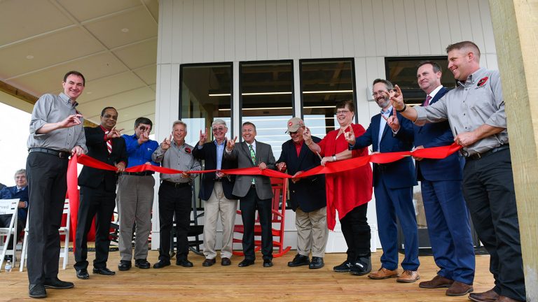 Dean Linton and others attend a ribbon cutting and dedication at the new Howling Cow Dairy Education Center and Creamer