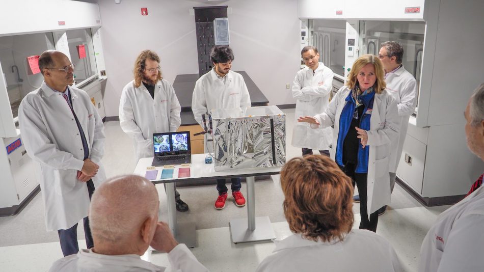professors gather in the organic and carbon electronics lab