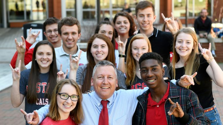 Dean Linton doing wolf hands with students