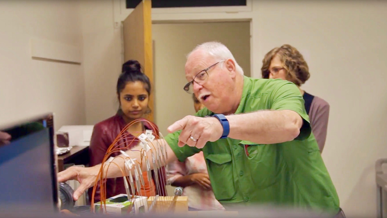 Tom Banks working with students in a lab