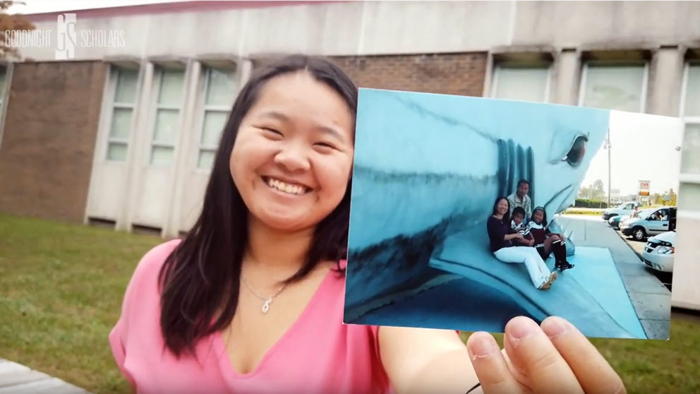 Sandy Lin holding a photo of her family
