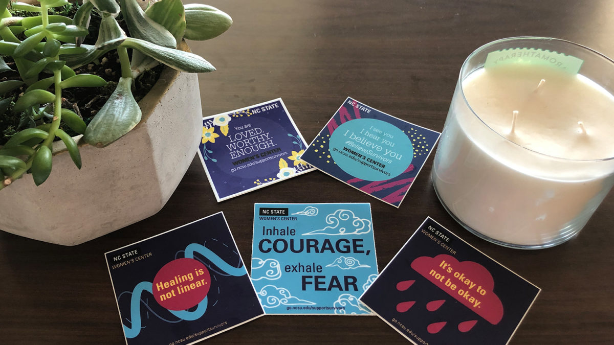encouraging stickers supporting survivors in a tableau with a plant and a candle