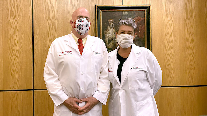 Dianne Dunning and Steve Marks pose in their masks and coats of excellence