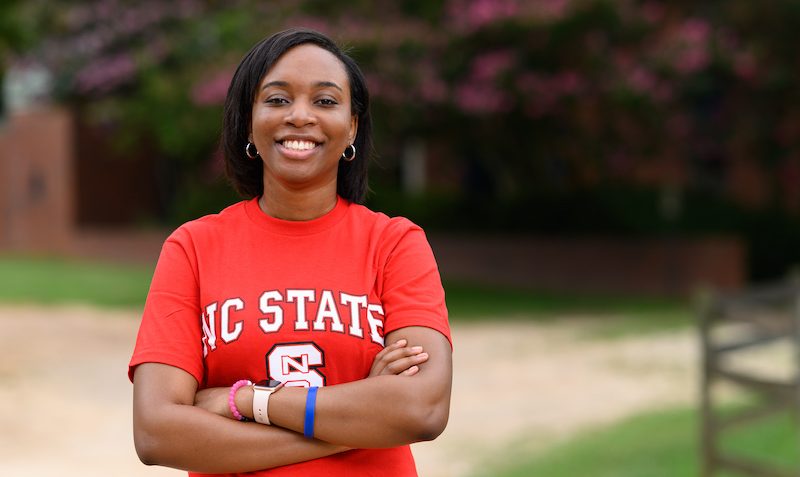 Kinnidy Coley standing outside in an NC State tee shirt