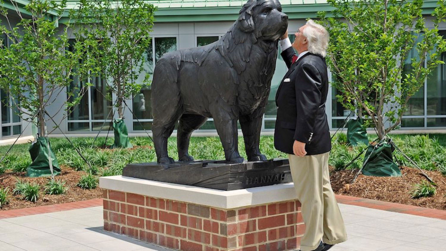 Randy Ward embraces the bronze statue of his pet Hannah, a Newfoundland that greets visitors to the Terry Center, in 2011.
