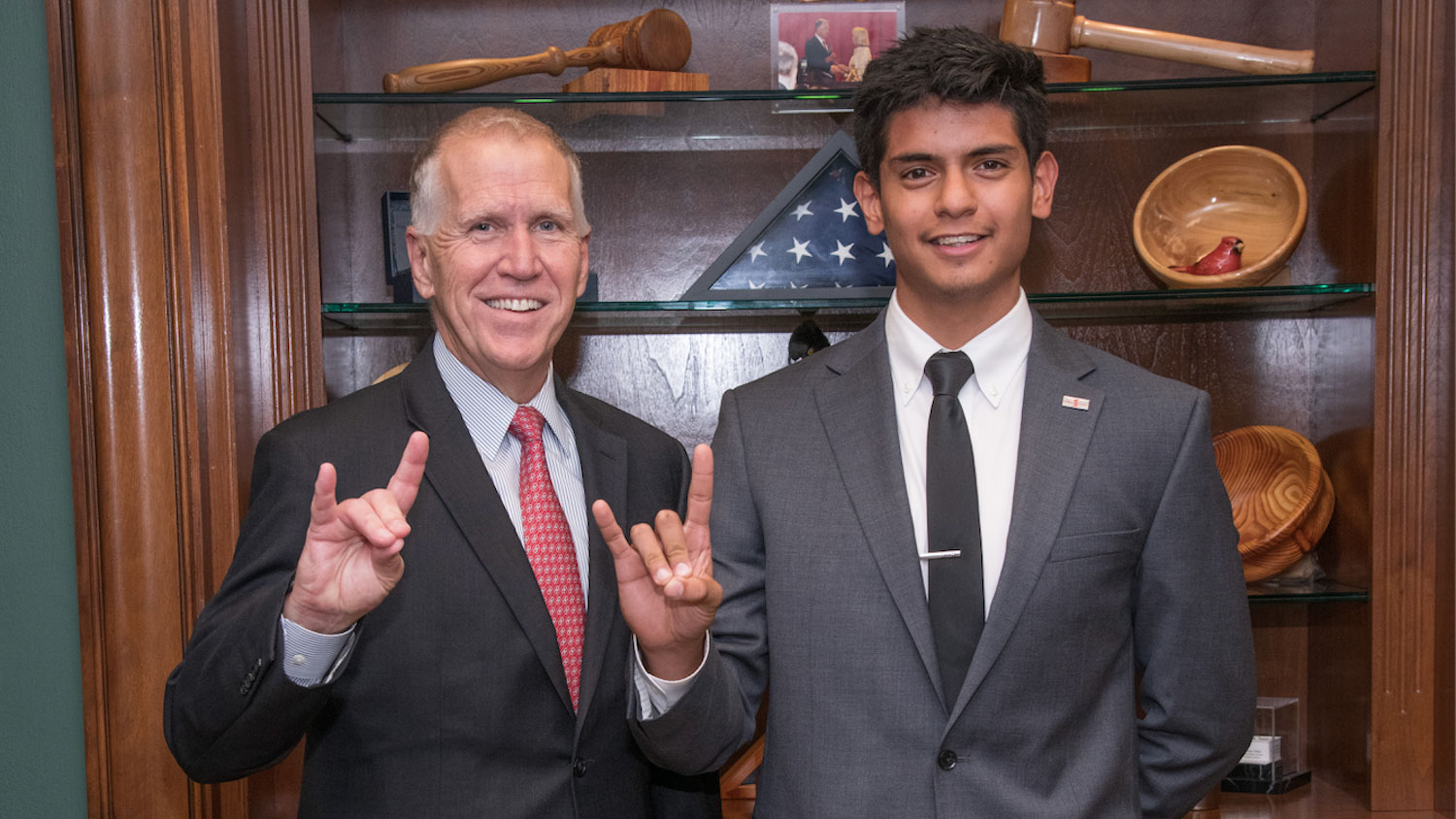 Ray Villalobos and Thom Tillis holding up the wolf ears symbol
