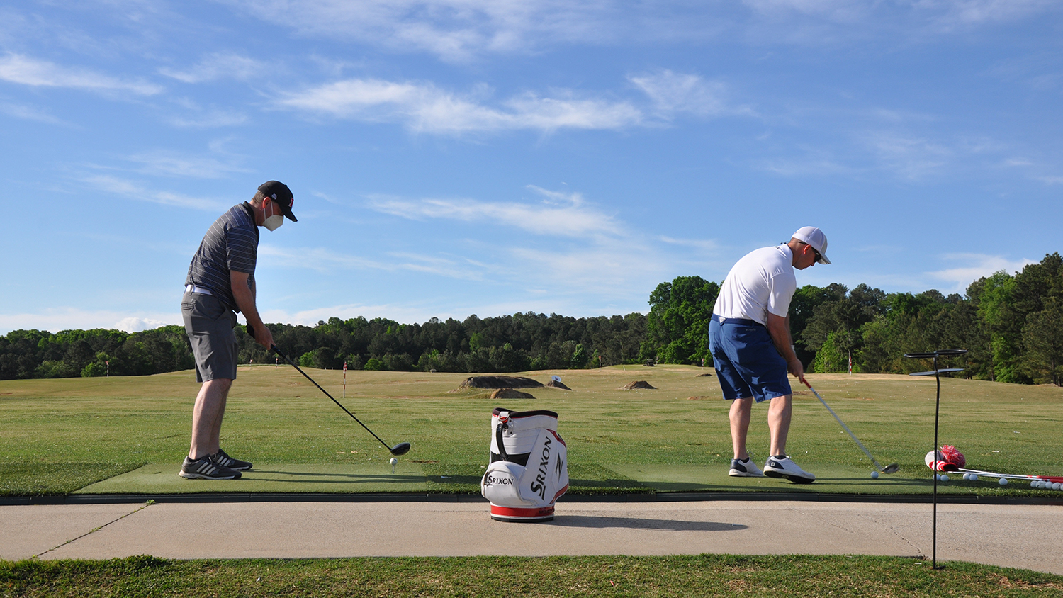 golfers teeing off