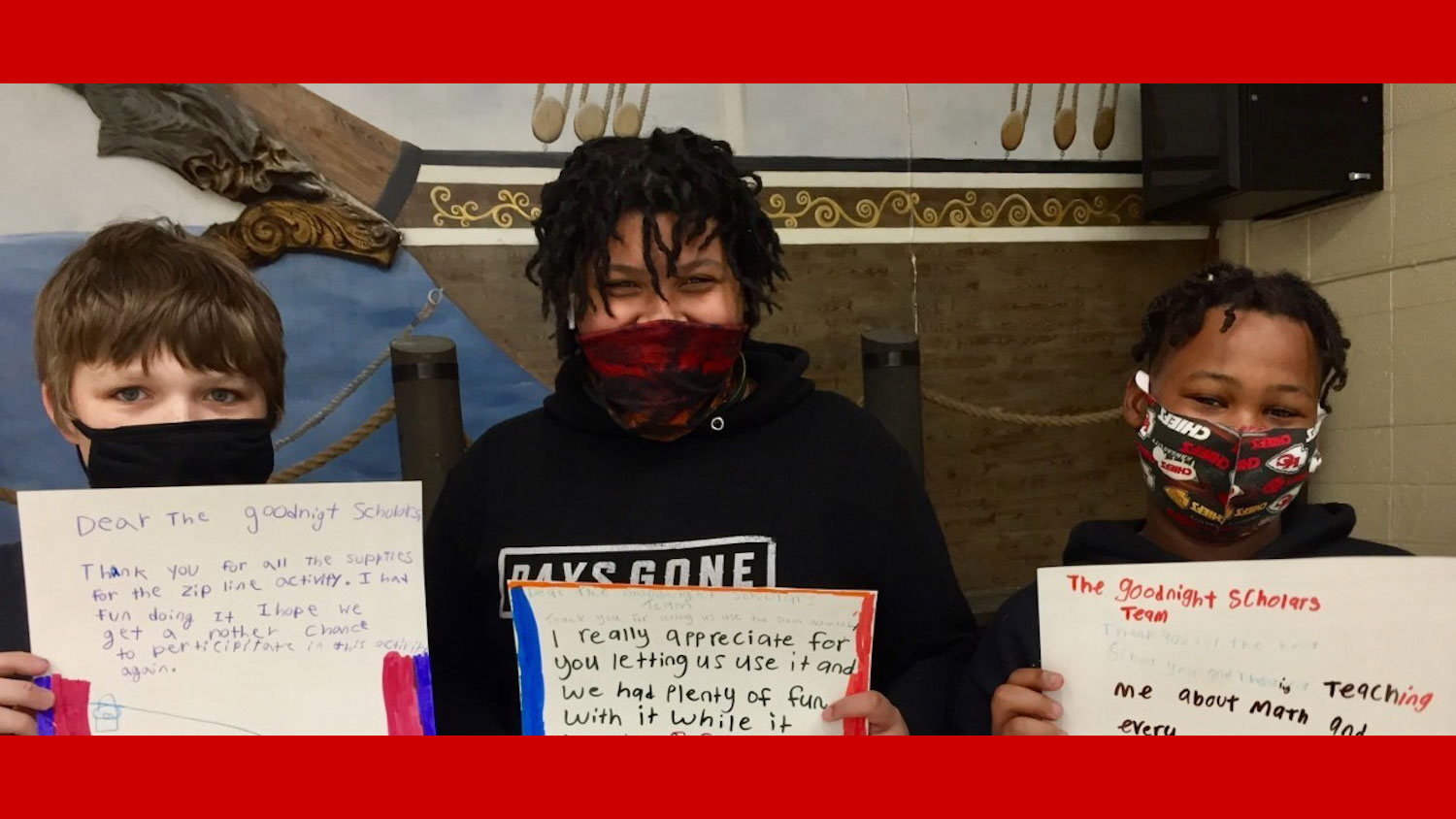 Kids holding Goodnight thank-you letters