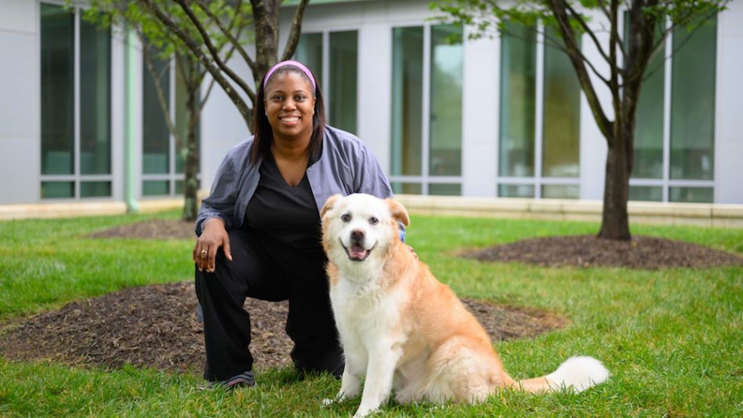 Keischa Williams poses with her dog, Phife, who underwent Petco-funded cancer treatment. Photo by John Joyner/NC State Veterinary Medicine