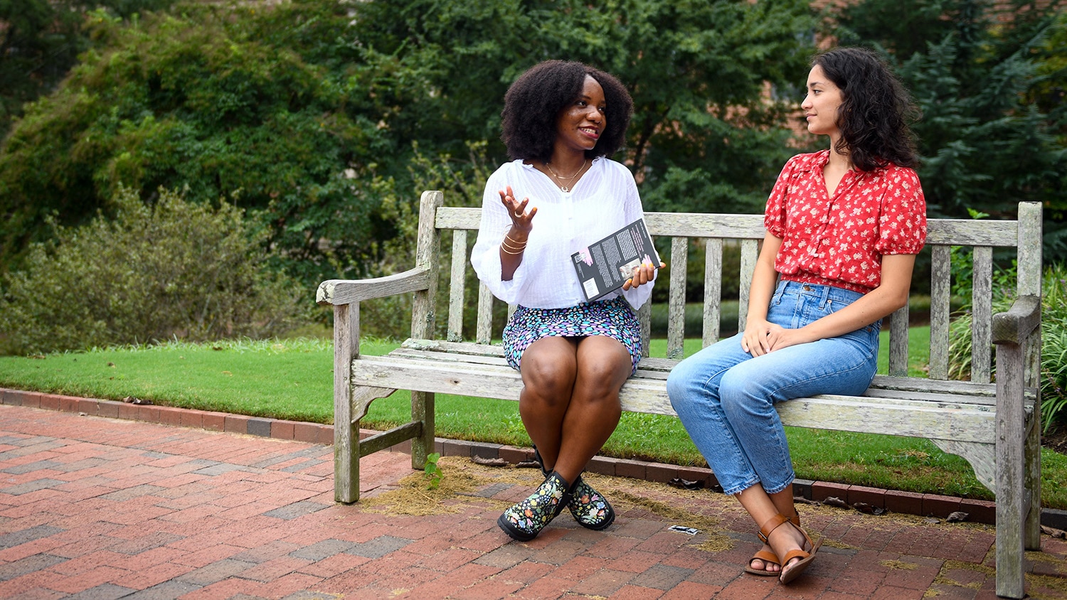 MFA students sitting on a bench