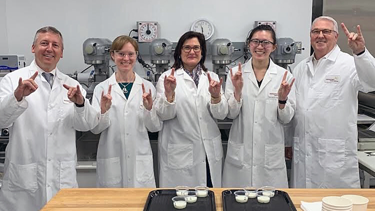 Katie Maloney, second from left, welcomes Wolfpack VIPs to her lab at Novozymes. From left are Richard Linton, dean of NC State's College of Agriculture and Life Sciences; Maloney; Novozymes' Vanessa Rising and Sonia Su; and NC State Chancellor Randy Woodson.