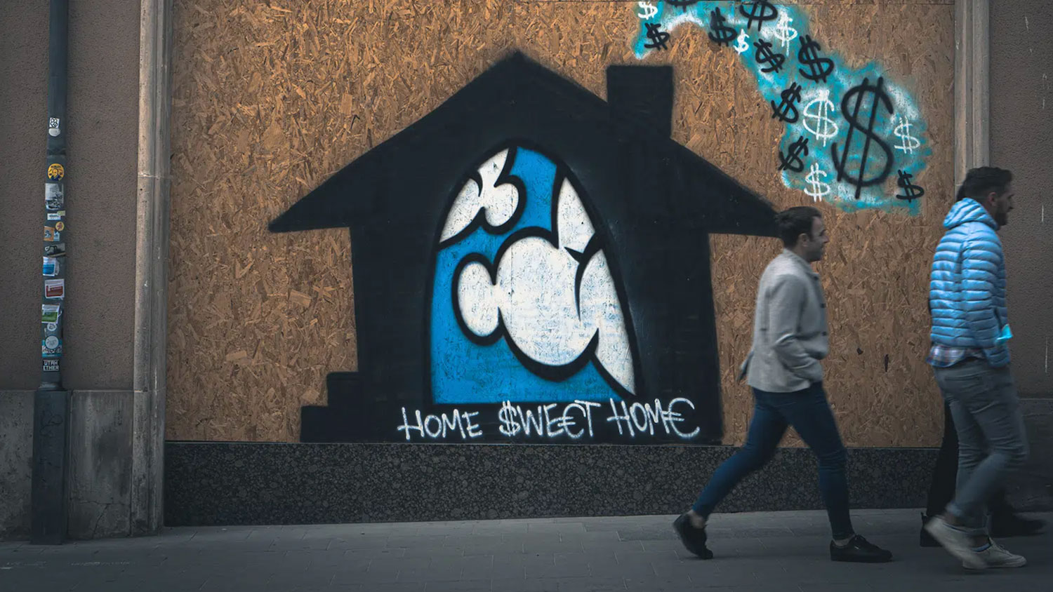 People walking by homelessness mural Photo by Mika Baumeister/unsplash.com