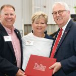 Chancellor Randy Woodson standing with two new Pullen Society members, holding a Pullen Society certificate.