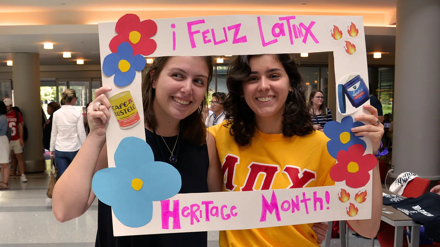 students holding Latinx Heritage Month sign