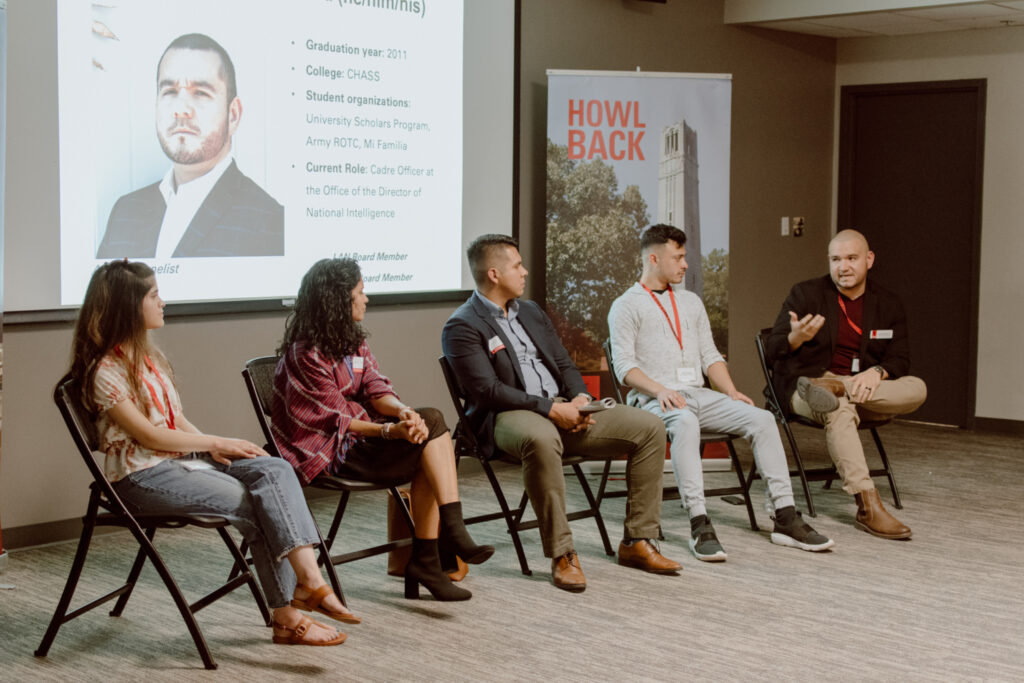 students and alumni talk on a panel dicusson at a LAN networking event