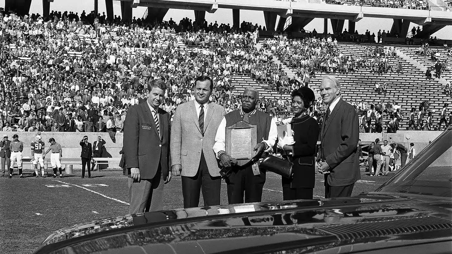 Chester Grant, center, is honored during a halftime event at Carter-Finley Stadium in 1970.