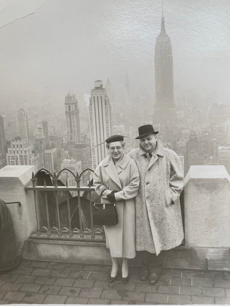 Black and white photo of Ann and Douglas Opitz with a city scape in the background