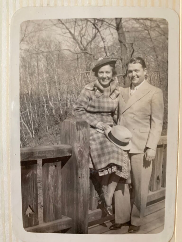 Black and white photo of Ann and Douglas Optiz on a wooden bridge