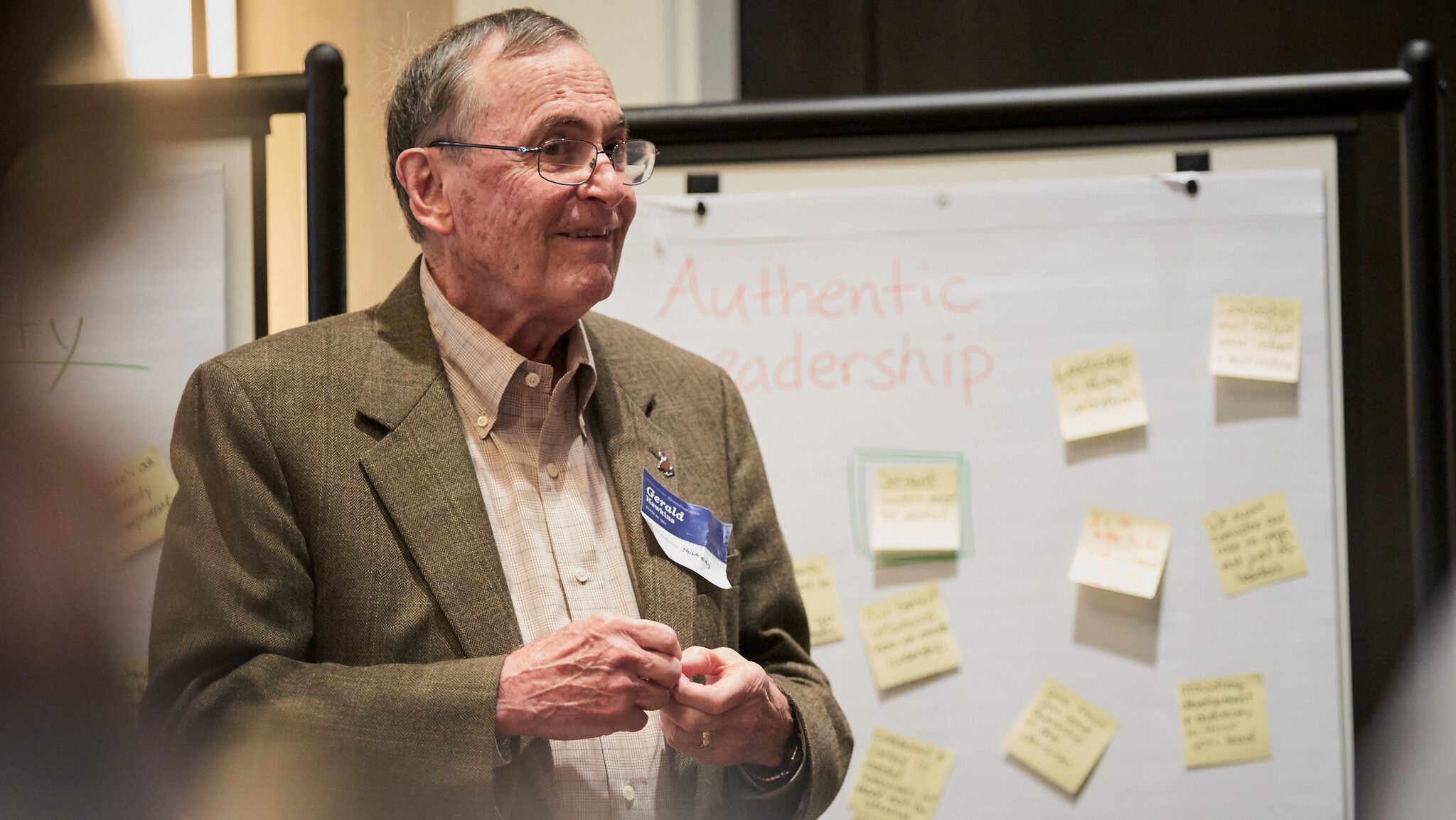 Dr. Gerald Hawkins standing in front of a whiteboard that says authentic leadership