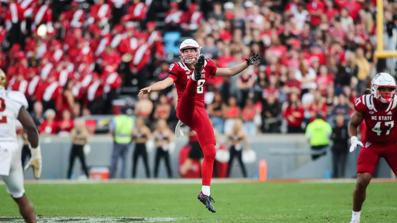 Caden Noonkester kicking a football at Carter-Finley Stadium. Photo by Jed Gammons for NC State Athletics