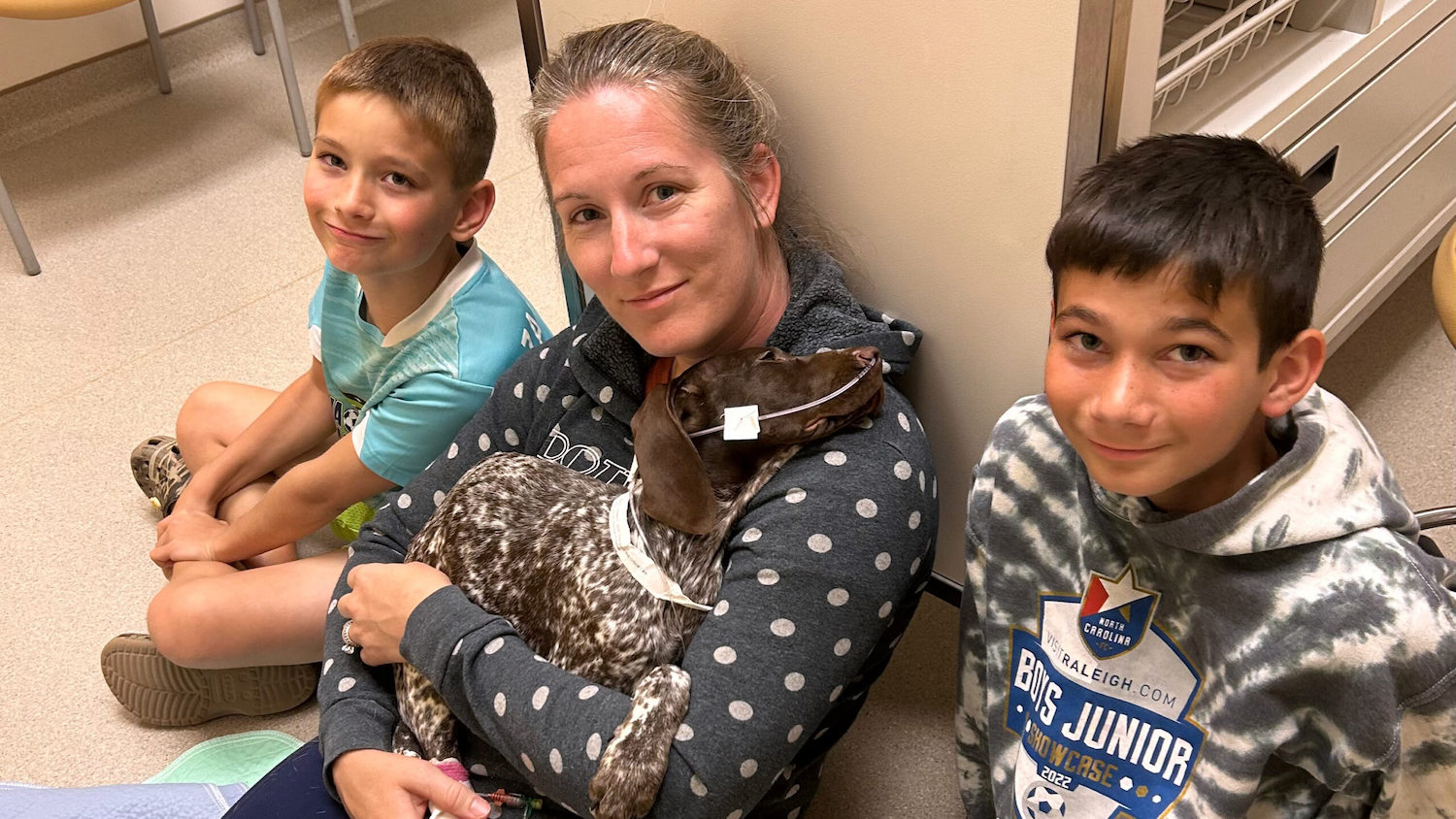 Chelsea Tovar and her sons visit their German shorthaired pointer puppy, Hollen, at NC State Veterinary Hospital in May. Hollen had a nasogastric feeding tube giving her sodium supplements. (photo courtesy of the Tovar family)