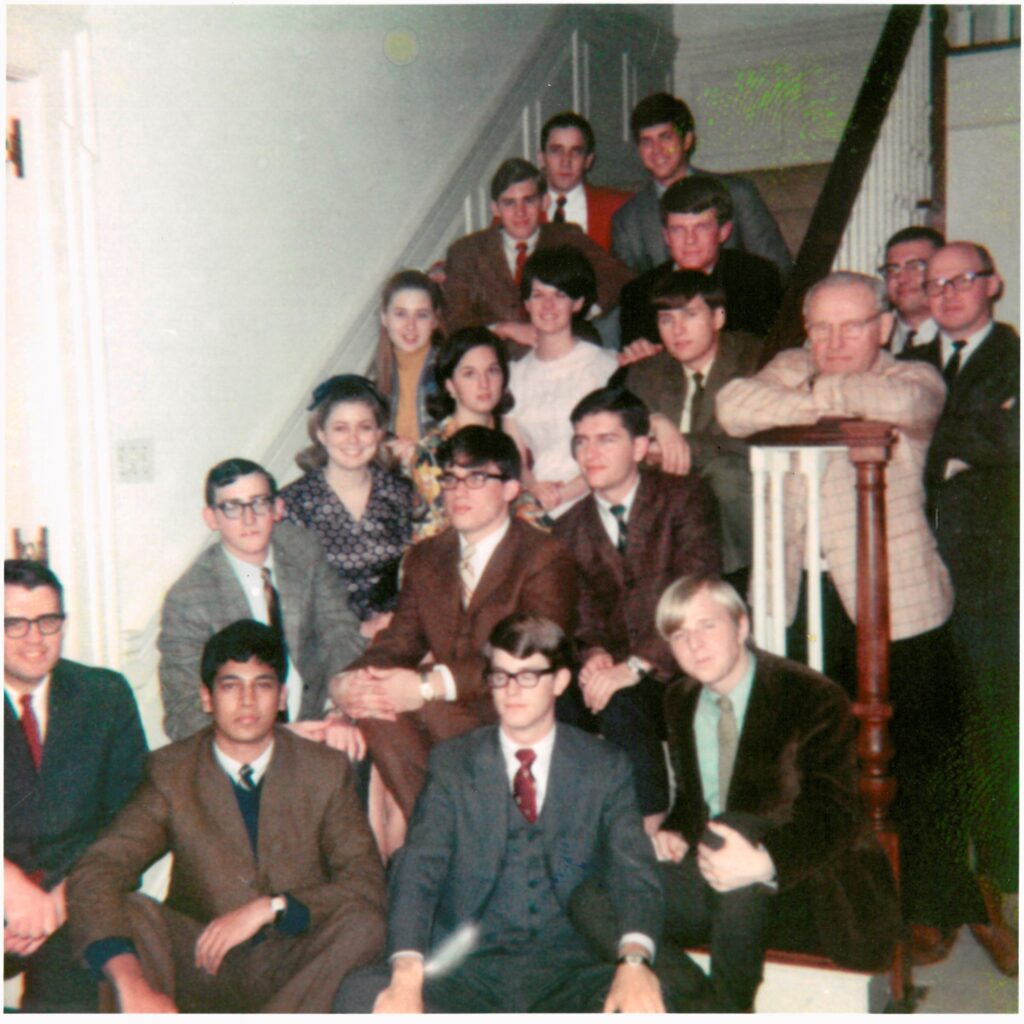 The first class of Caldwell fellows sitting on a staircase