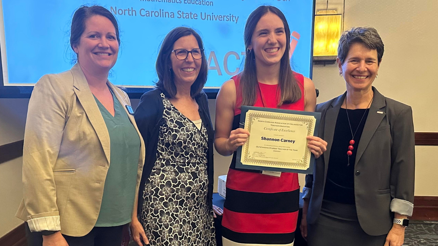 Shannon Carney, third from left, is presented with the 2023 North Carolina Association of Colleges for Teacher Education Student Teacher of the Year award.
