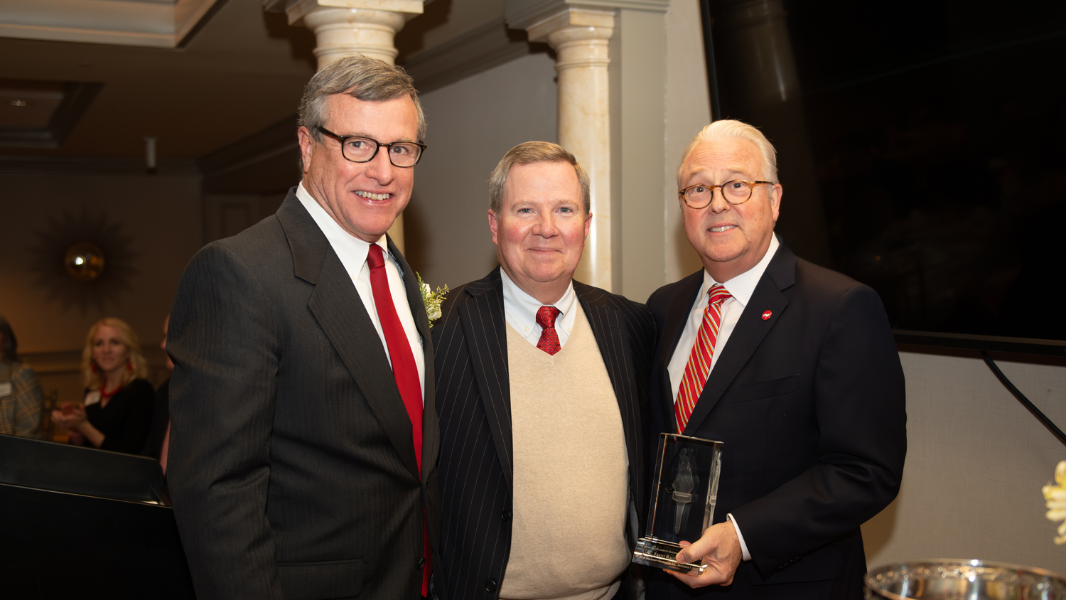 From right: Chancellor Randy Woodson and NC State University Foundation Chair Mike Constantino present Trent Ragland with the 2023 Jerry and Elizabeth Godwin Red Torch Award.