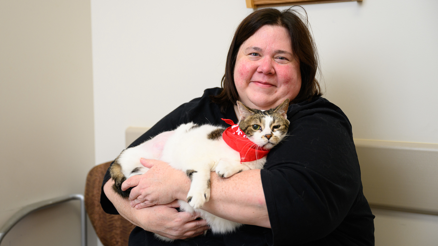 Margaret Whitler holds her 13-year-old cat, Dule, on a recent visit to the NC State Veterinary Hospital. (John Joyner/NC State CVM)