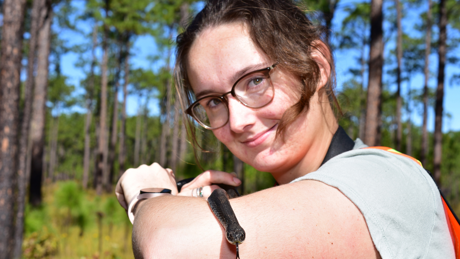 Gabby Landry holding a snake. Photo Credit: Sam Schoenberg/NC State Department of Forestry and Environmental Resources