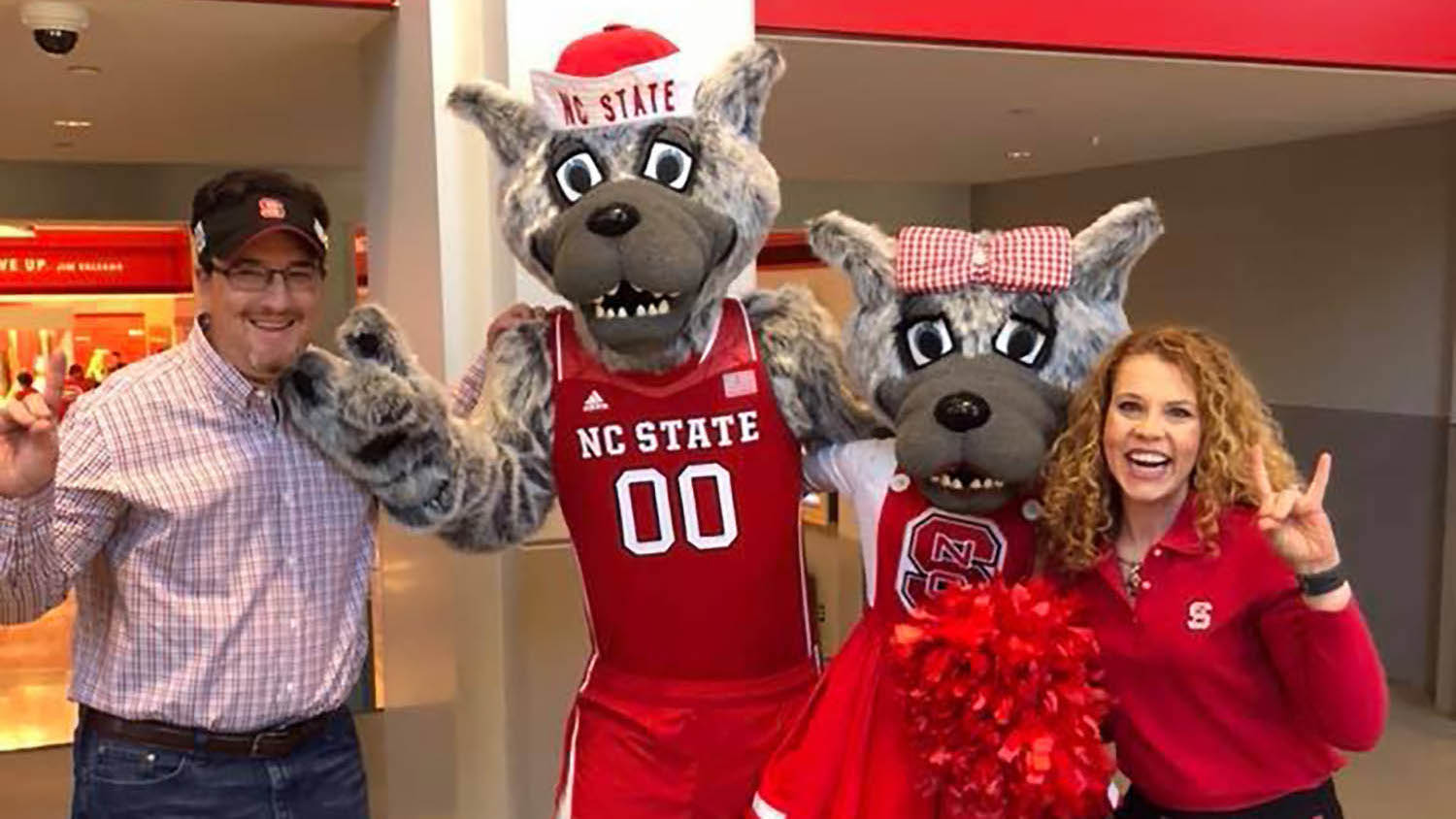 Beth Farrell, far right, with Mr. and Ms. Wuf and another NC State fan in Reynolds Coliseum