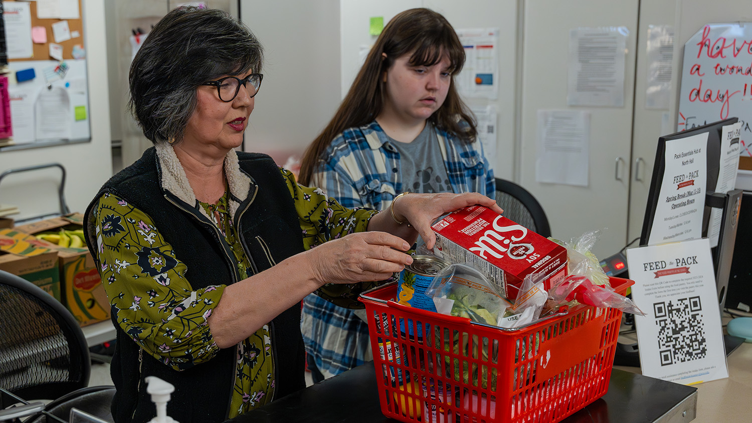 Two women help stock the Feed the Pack food pantry
