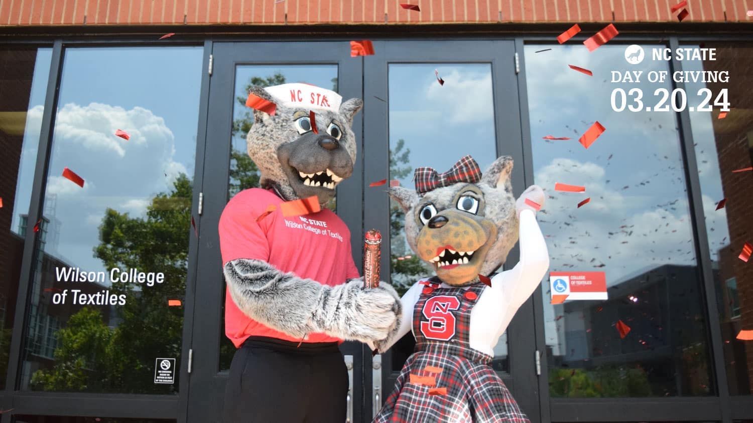 Mr. and Ms. Wuf celebrating in front of the Wilson College of Textiles