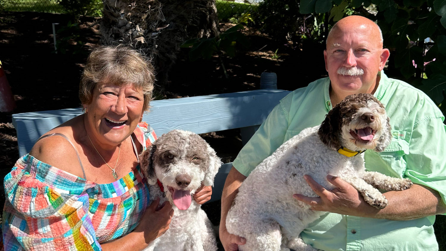Dr. Jackie Jaloszynski and Sid Bragg pose with their Lagotto Romagnolo puppies, Hudson and Bella, near their home in North Carolina's Crystal Coast. (Courtesy of Jackie Jaloszynski)