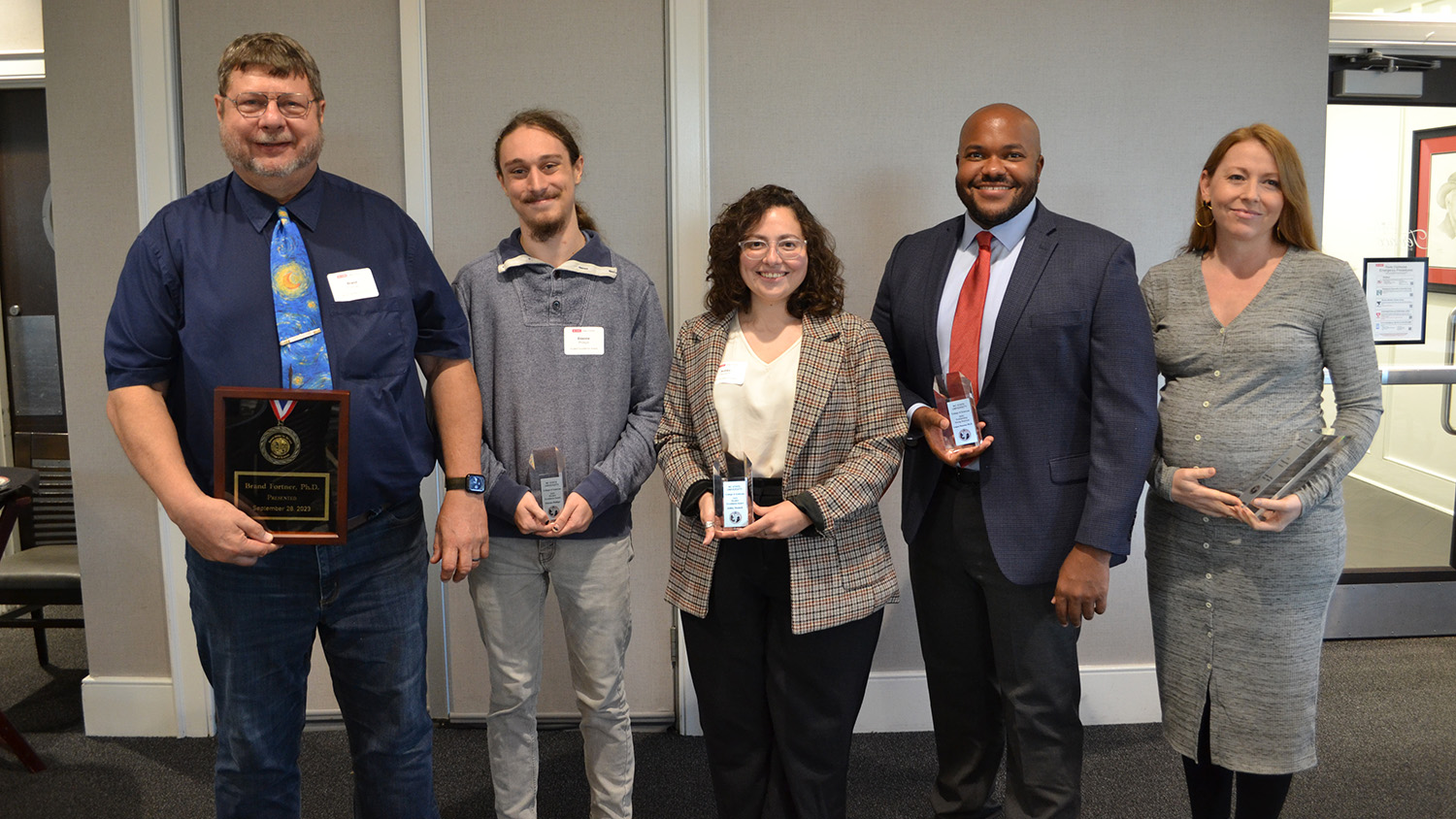 Etienne Phillips stands alongside College of Sciences award recipients
