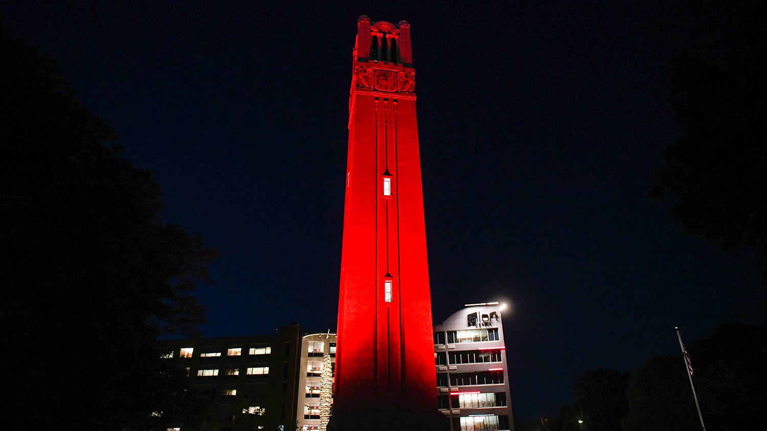 The Memorial Belltower lit red
