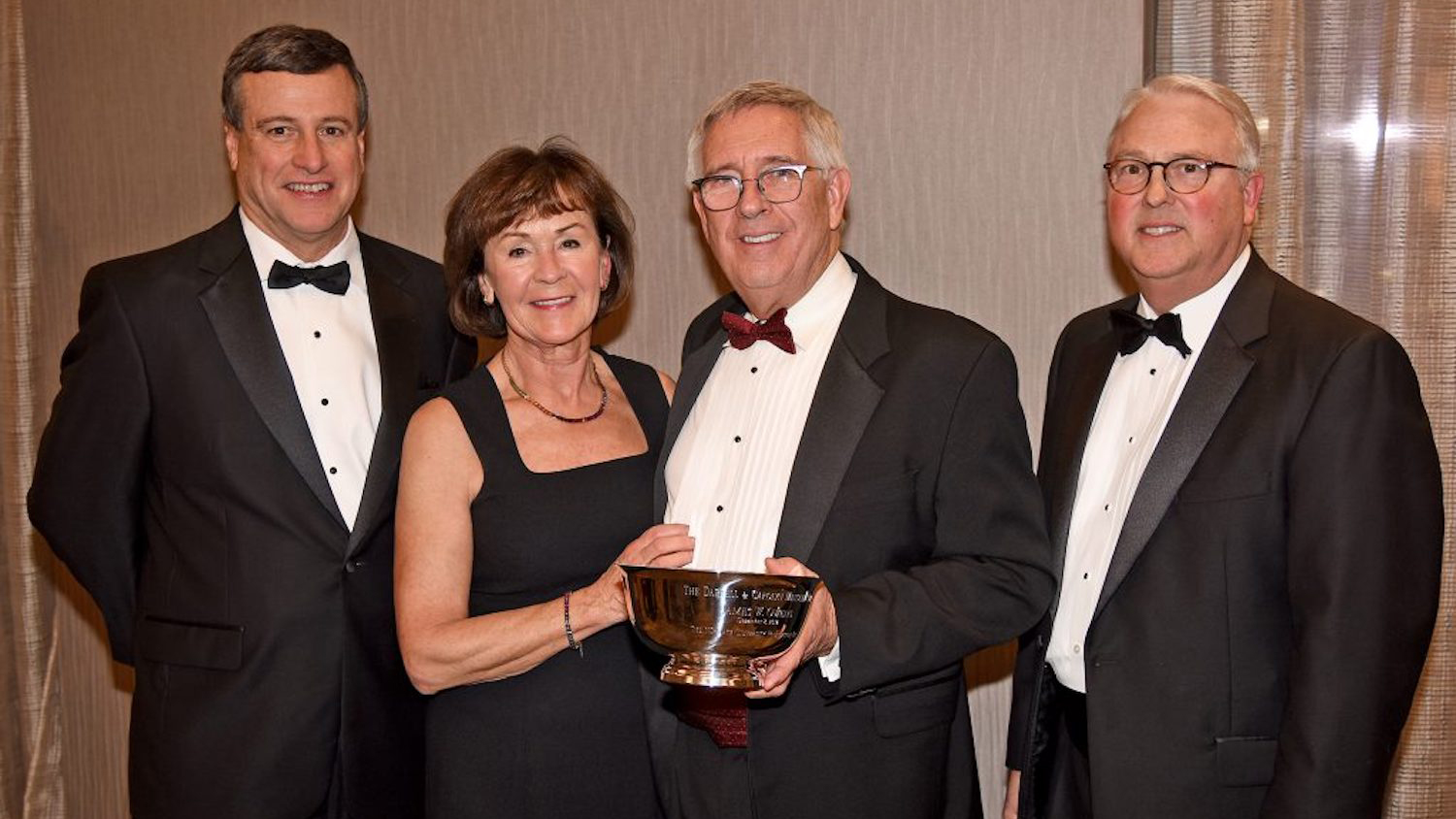 Former NC State University Foundation Board Chair Trent Ragland (left) and Chancellor Randy Woodson (right) with Jim and Kathrine Owens at the 2017 Menscer Cup celebration.