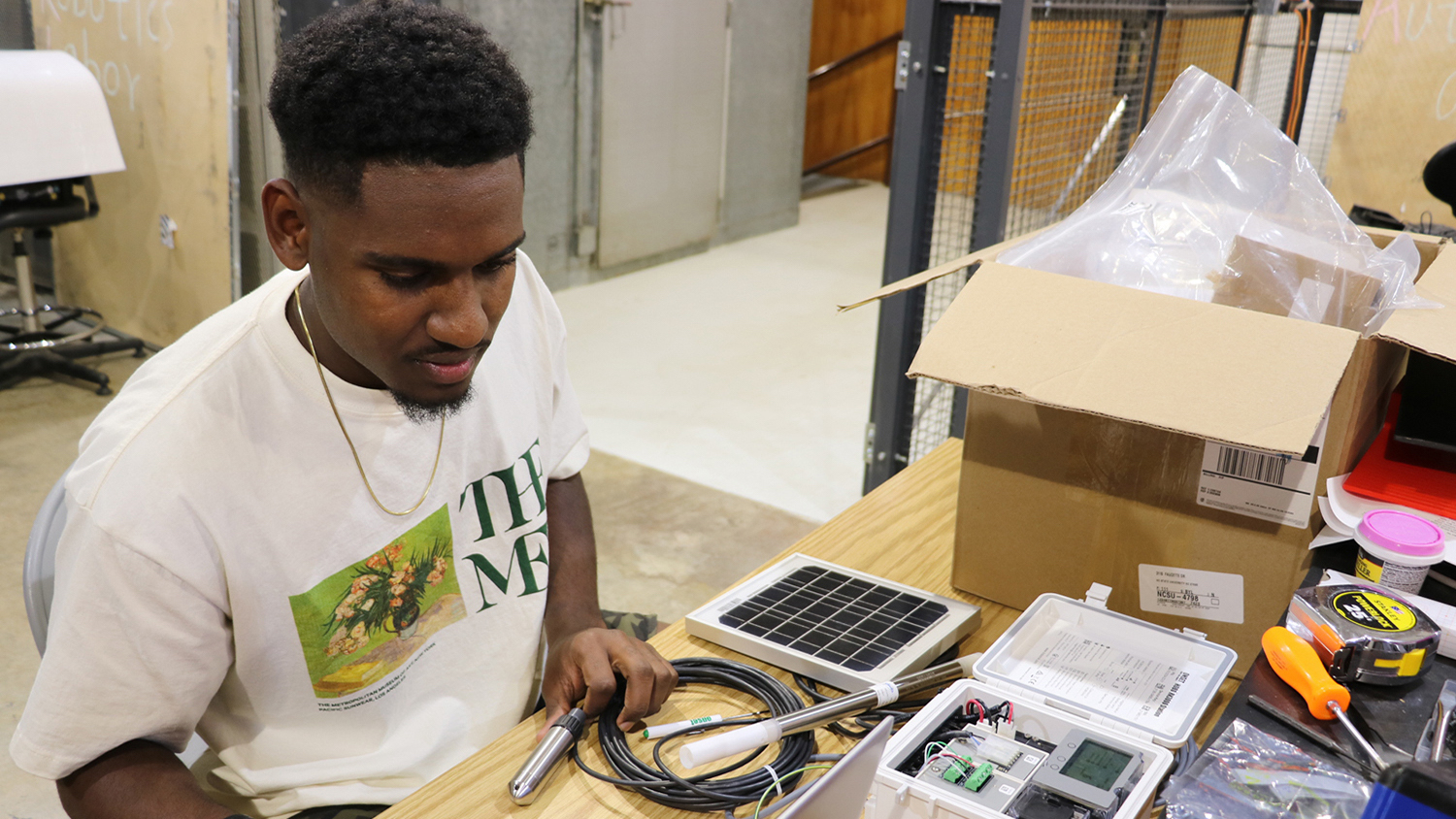 Taj Hewitt working at a table