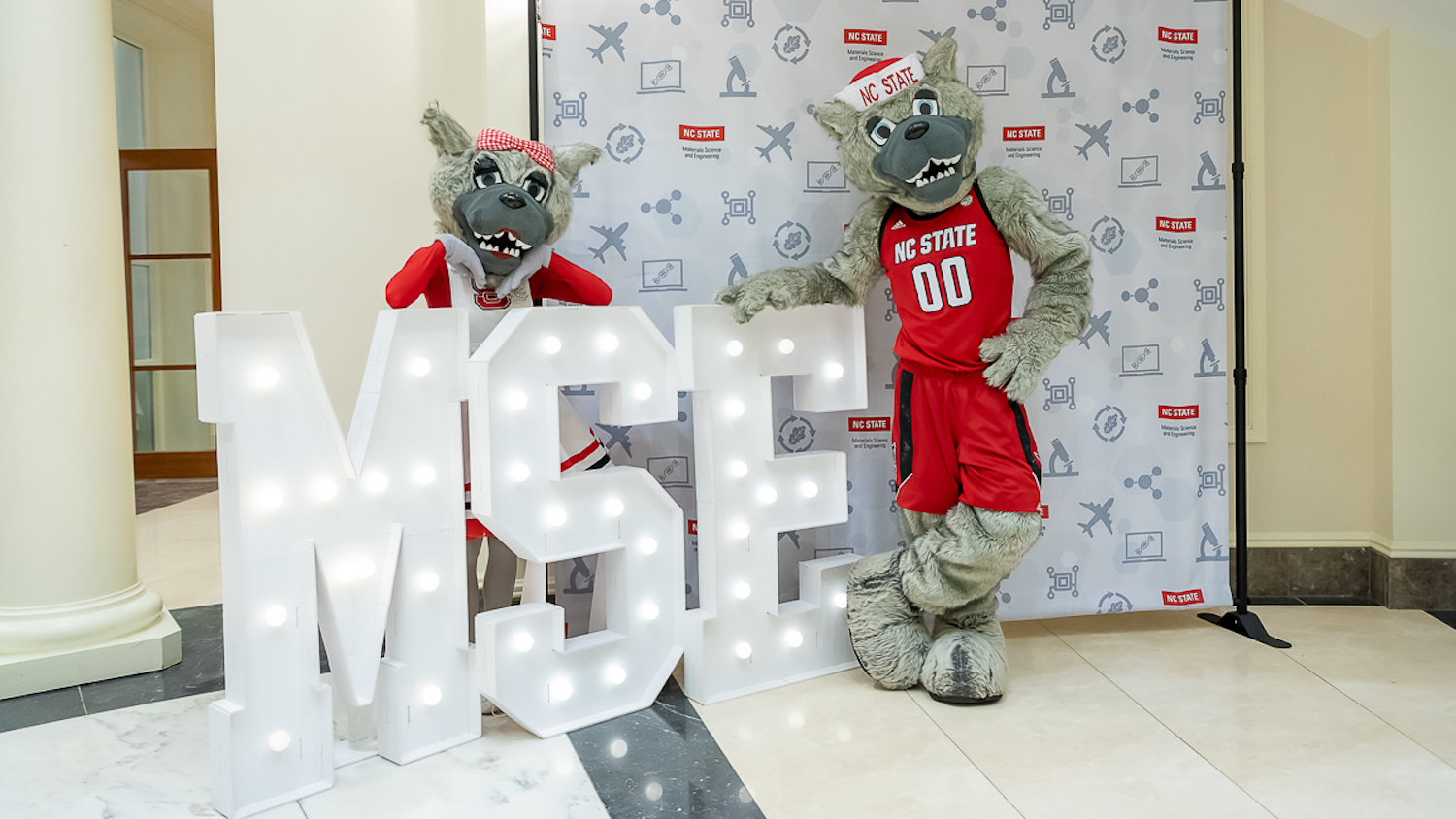 Mr. and Ms. Wuf beside an MSE sign.