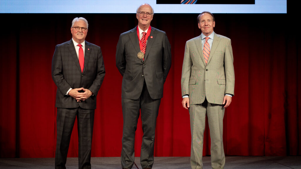 Charlie Stallings (center) on stage with Chancellor Randy Woodson and Ed Weisiger Jr.